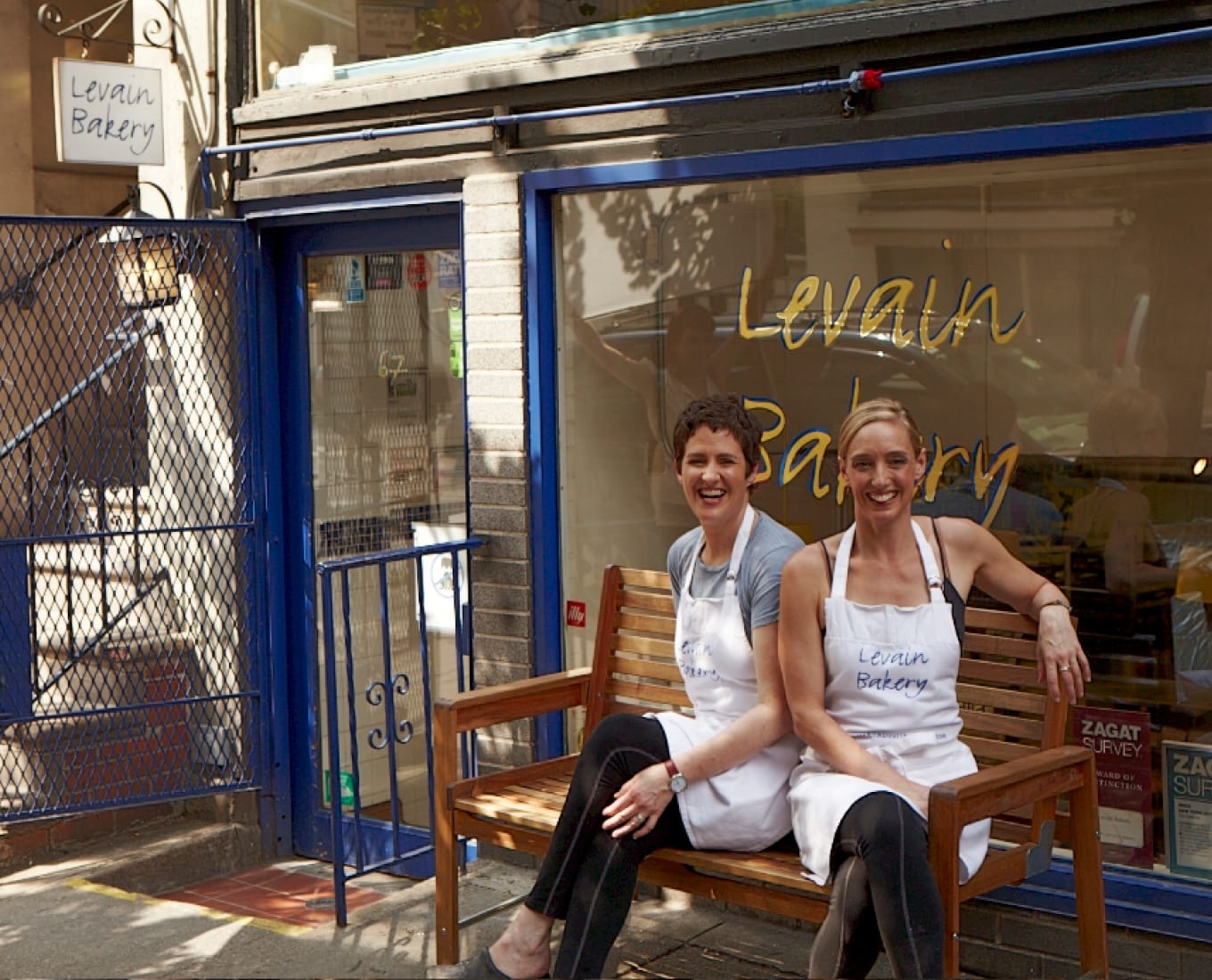 Founders, Pam & Connie, sitting on a bench outside the original Levain Bakery